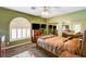 Spacious bedroom with a large window, two TVs, and mirrored closet doors at 7015 N Jensen St, Las Vegas, NV 89149