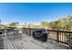 Wooden deck features patio furniture, grill, and scenic backyard views at 7015 N Jensen St, Las Vegas, NV 89149