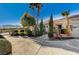 Single-story home with a spacious driveway and desert landscaping at 7015 N Jensen St, Las Vegas, NV 89149