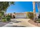 Home exterior featuring a large driveway and well-maintained landscaping at 7015 N Jensen St, Las Vegas, NV 89149