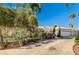 Beautiful home exterior with lush landscaping and a long driveway at 7015 N Jensen St, Las Vegas, NV 89149