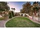 Landscaped front yard with lush grass and trees at 7015 N Jensen St, Las Vegas, NV 89149