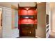 Custom-built home bar with red interior lighting and ample storage at 7015 N Jensen St, Las Vegas, NV 89149