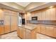Modern kitchen with an island and stainless steel appliances at 7015 N Jensen St, Las Vegas, NV 89149