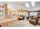 Open concept living room with kitchen and island, featuring hardwood floors and a ceiling fan at 7015 N Jensen St, Las Vegas, NV 89149