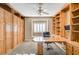Home office with built-in bookshelves and a large desk at 7015 N Jensen St, Las Vegas, NV 89149