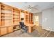 Home office with built-in bookshelves and a large desk at 7015 N Jensen St, Las Vegas, NV 89149