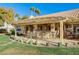 Covered patio with seating area and backyard access at 7015 N Jensen St, Las Vegas, NV 89149