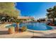 Inviting circular pool with waterfall feature and landscaping at 7015 N Jensen St, Las Vegas, NV 89149