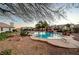 Inviting swimming pool with diving board, surrounded by a landscaped backyard at 7015 N Jensen St, Las Vegas, NV 89149
