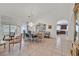 Open-concept living and dining area with tile floors and classic decor, adjacent to the kitchen at 8216 Wooden Windmill Ct, Las Vegas, NV 89131