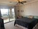 Cozy bedroom with a ceiling fan, a balcony with a view, and carpeted floors at 12381 Foxtail Run Ave, Las Vegas, NV 89138