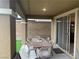 Covered patio featuring a large wood table, seating for six, and a brick wall at 12381 Foxtail Run Ave, Las Vegas, NV 89138