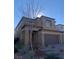 Two-story house with a brown exterior, two-car garage, and landscaping at 12381 Foxtail Run Ave, Las Vegas, NV 89138