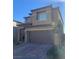 Two-story house with a brown exterior, two-car garage, and a paved driveway at 12381 Foxtail Run Ave, Las Vegas, NV 89138