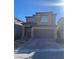 Two-story house with brown exterior, two-car garage, and stone-paved pathway at 12381 Foxtail Run Ave, Las Vegas, NV 89138