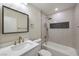 Stylish bathroom with white vanity and herringbone tile shower at 1408 Palm St, Henderson, NV 89011