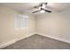 Bedroom with grey carpet, ceiling fan, and window at 1408 Palm St, Henderson, NV 89011