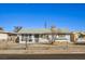 Ranch style home with a grey roof and chain link fence at 1408 Palm St, Henderson, NV 89011