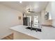 Modern kitchen with white cabinets, black appliances, and breakfast bar at 1408 Palm St, Henderson, NV 89011