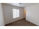 Simple bedroom with window, carpet, and neutral walls at 1420 Arlington Heights St, Las Vegas, NV 89110