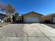 Single-story house with a two-car garage and gravel driveway at 1420 Arlington Heights St, Las Vegas, NV 89110