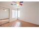 Bedroom with wood flooring, ceiling fan, and mirrored closet at 1473 Teddington Ct # 101, Las Vegas, NV 89102