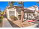 Walkway to the front door of a tan house with a garage at 1473 Teddington Ct # 101, Las Vegas, NV 89102