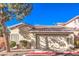 Tan stucco house with a two-car garage and desert landscaping at 1473 Teddington Ct # 101, Las Vegas, NV 89102