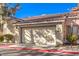 Two-car garage with tan automatic door and driveway at 1473 Teddington Ct # 101, Las Vegas, NV 89102