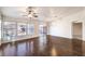 Bright living room with hardwood floors, large windows, and a ceiling fan at 1473 Teddington Ct # 101, Las Vegas, NV 89102