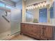 Bathroom featuring a dual-sink vanity with a wood finish, modern lighting, and a glass-enclosed shower at 1510 Fieldbrook St, Henderson, NV 89052