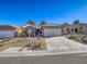 Charming single-story home featuring desert landscaping, a concrete driveway, and a two-car garage at 1510 Fieldbrook St, Henderson, NV 89052