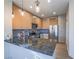 Modern kitchen with stainless steel appliances, stone countertops, and stylish pendant lighting at 1510 Fieldbrook St, Henderson, NV 89052