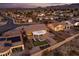 Aerial view of a house with backyard patio, firepit, putting green, and solar panels at 1645 Warrington Dr, Henderson, NV 89052