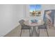 Bright dining area with a round table and gray chairs, overlooking a garden at 1645 Warrington Dr, Henderson, NV 89052