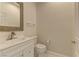 Clean and modern bathroom with white vanity and decorative mirror at 1656 Black Fox Canyon Rd, Henderson, NV 89052