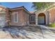 Inviting front entry with arched doorway and neutral color scheme at 1656 Black Fox Canyon Rd, Henderson, NV 89052