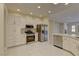 White kitchen with stainless steel appliances and large island at 1656 Black Fox Canyon Rd, Henderson, NV 89052