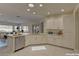 White kitchen with island, stainless steel appliances, and ample cabinet space at 1656 Black Fox Canyon Rd, Henderson, NV 89052