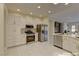 Modern kitchen with white cabinets, stainless steel appliances, and an island at 1656 Black Fox Canyon Rd, Henderson, NV 89052