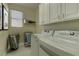 Bright laundry room, featuring washer, dryer, and ample storage at 1656 Black Fox Canyon Rd, Henderson, NV 89052