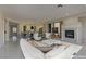 Virtually staged living room features modern furniture and fireplace at 1656 Black Fox Canyon Rd, Henderson, NV 89052