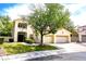 Two-story house with attached two-car garage, landscaping, and a tree in the front yard at 1813 Francisco Peak Pl, Las Vegas, NV 89128