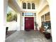 Elegant entryway with a double red door, tile flooring, and a bench at 1813 Francisco Peak Pl, Las Vegas, NV 89128