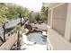 Luxury pool with waterfall feature and spacious patio area at 1813 Francisco Peak Pl, Las Vegas, NV 89128