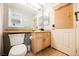 Bathroom with granite countertop, wooden cabinets and toilet at 2000 White Falls St, Las Vegas, NV 89128