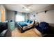 Bedroom with teal bedding, ceiling fan, and mini-fridge at 2000 White Falls St, Las Vegas, NV 89128