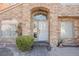 White front door entry with stonework and landscaping at 2000 White Falls St, Las Vegas, NV 89128