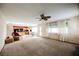 Bright living room with ceiling fan, fireplace, and large windows at 2000 White Falls St, Las Vegas, NV 89128